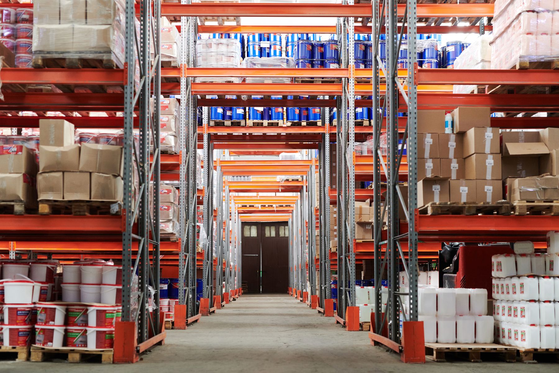 Warehouse aisle with stacked goods, used for operational automation.
