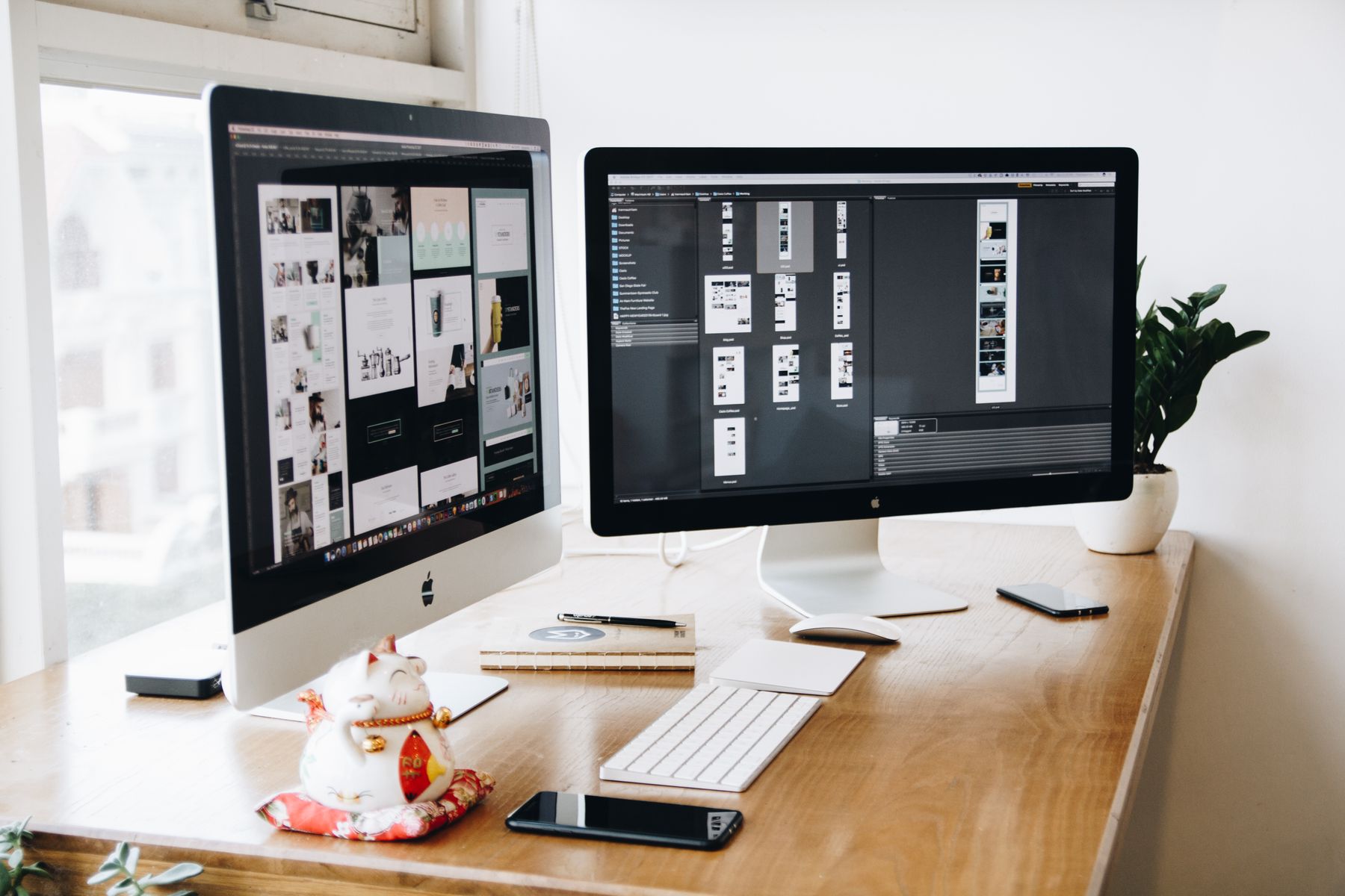 Studio desks with screens showing a website and interface layouts.